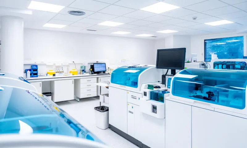 A life-sciences lab bench with analyzers and a monitor
