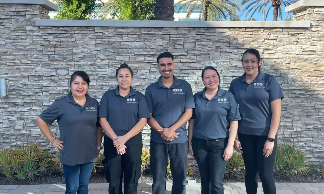 Five members of the EBS Maintenance team in grey uniforms