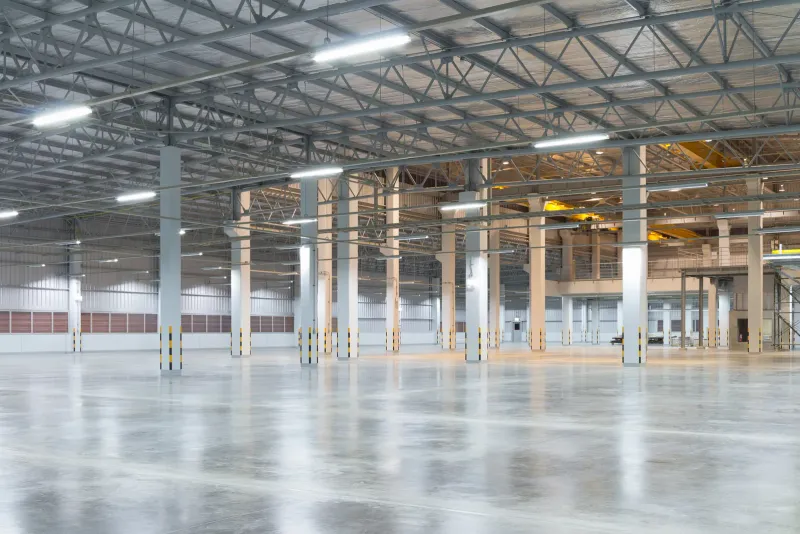 An empty warehouse with a clean, polished concrete floor